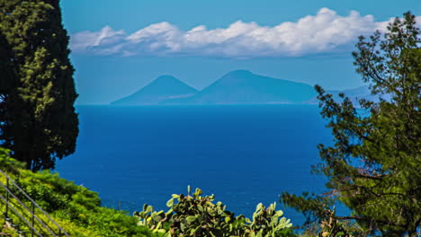 Timelapse-of-seascape-and-clouds-passing-quickly-over-mountains-in-background