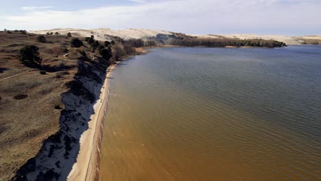 aerial flying over sand beach coastline at naglis national park, curonian spit, lithuania