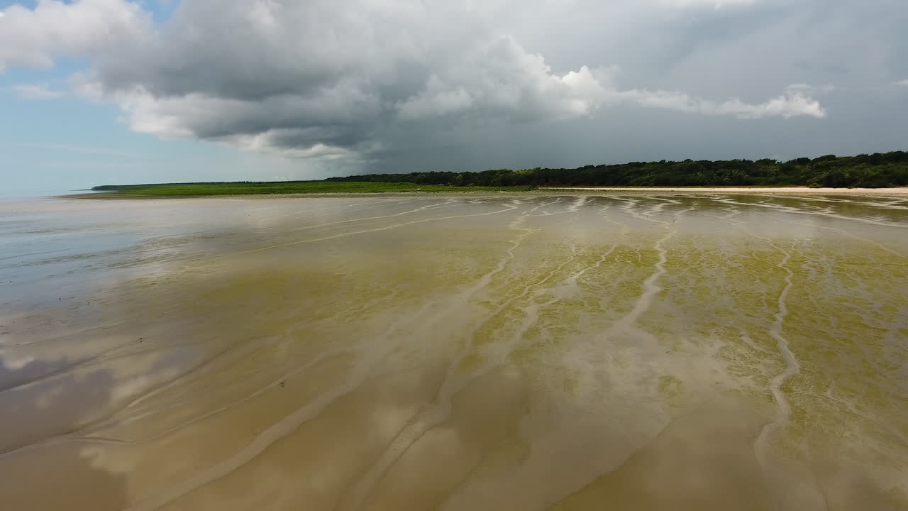 Low altitude fight over a sandy muddy beach Awala Yalimapo village Guiana
