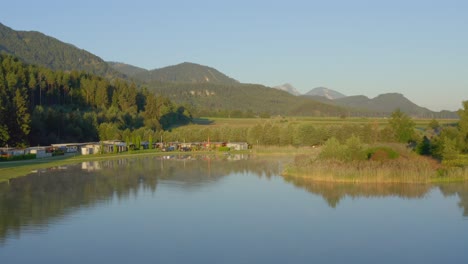 a done shot of a lakeside campsite during sunset