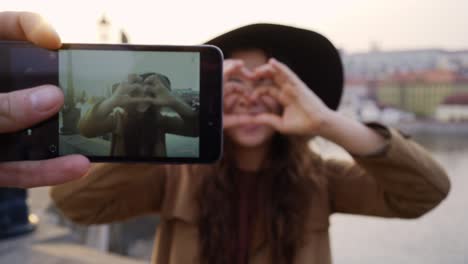 pov couple taking photo on phone against sights in prague