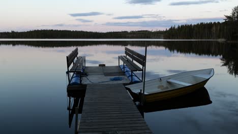 Scandinavian-calm-lake-with-a-pontoon-and-a-boat