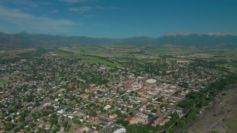 aerial cinematic drone mid summer downtown salida colorado near buena vista on arkansas river riverside park scout surfing wave biking hiking rafting rocky mountain up high up backward movement