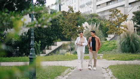 Confident-colleagues-crossing-alley-together-vertically.-Businesscouple-talking