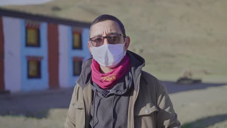 middle-aged east asian man covered with protective disposable mask standing