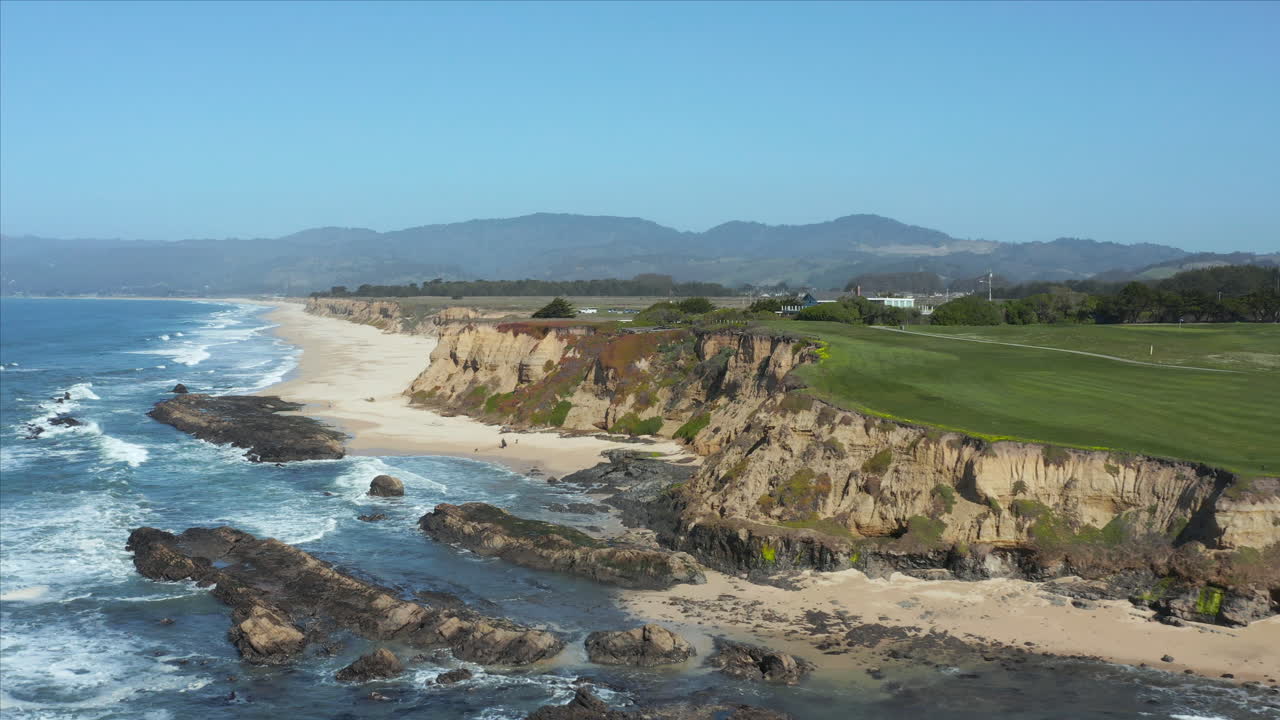 Aerial Drone sliding shot of the cliffs overlooking the crushing waves at Half Moon. Bay, California, USA