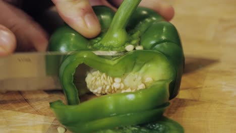 motion controlled slow motion shot of cutting green paprika