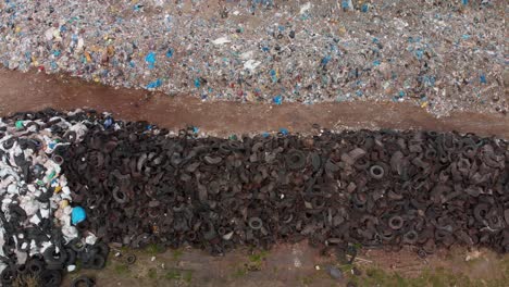 aerial overhead pan over piles of waste in a large landfill