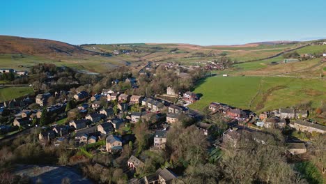 Aerial-drone-footage-of-the-small-village-of-Denshaw,-a-typical-rural-village-in-the-heart-of-the-Pennines