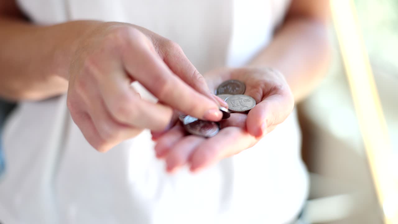 Woman Holding Coins in Hand