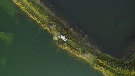 Aerial-of-small-stretch-of-land-surrounded-by-water,-perfect-fishing-spot