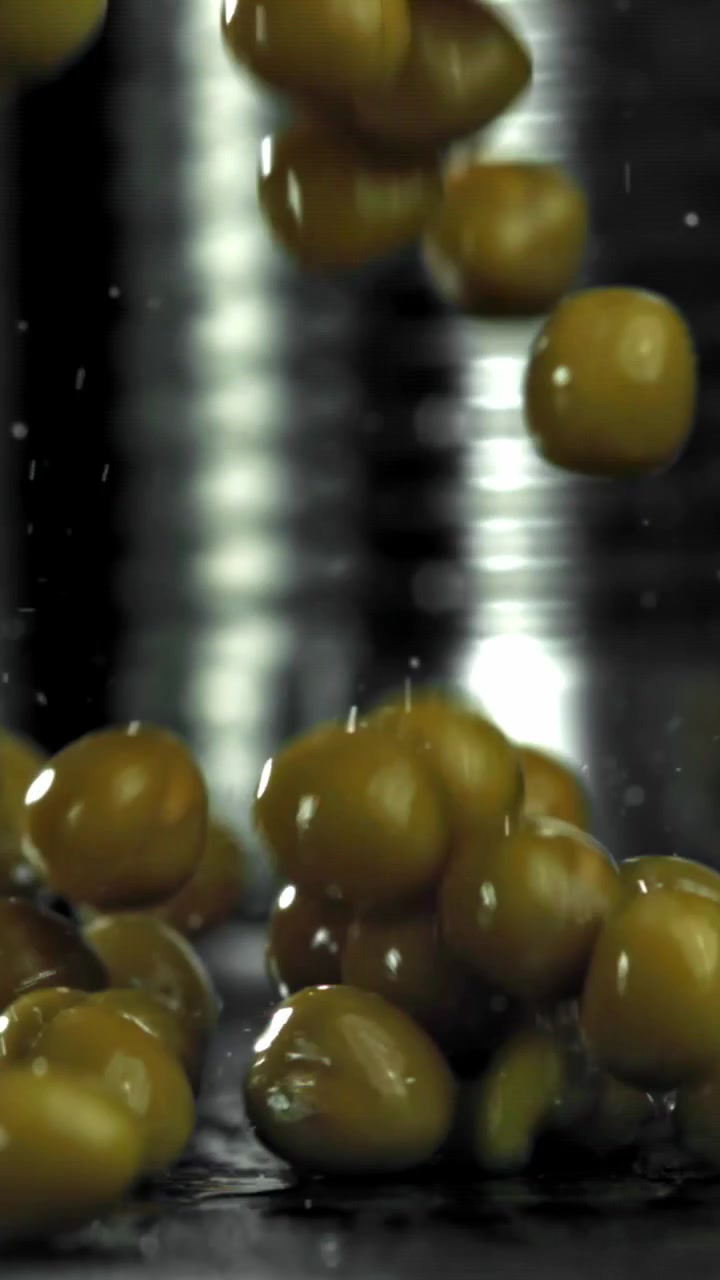Olive verdi fresche che cadono e schizzano al rallentatore