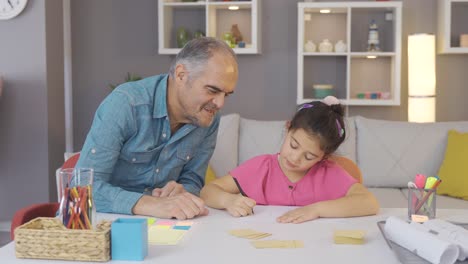 Grandpa-studying-with-his-grandson-in-notebook-and-book.