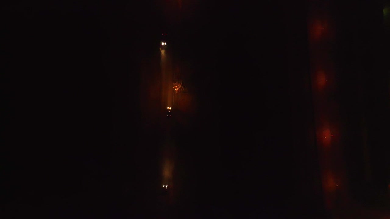 Car driving on the road in black darkness