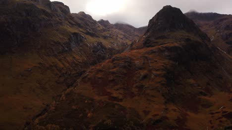 A-high-view-of-the-Scottish-Highlands-full-of-hills-and-rocks-covered-with-fog,-a-place-called-Glencoe