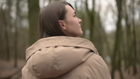 A-Young-Girl-Walks-Through-The-Forest-Looking-From-Side-To-Side-1