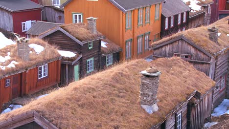 thatch roofed wooden buildings line the streets of the old historic mining town of roros in norway 1