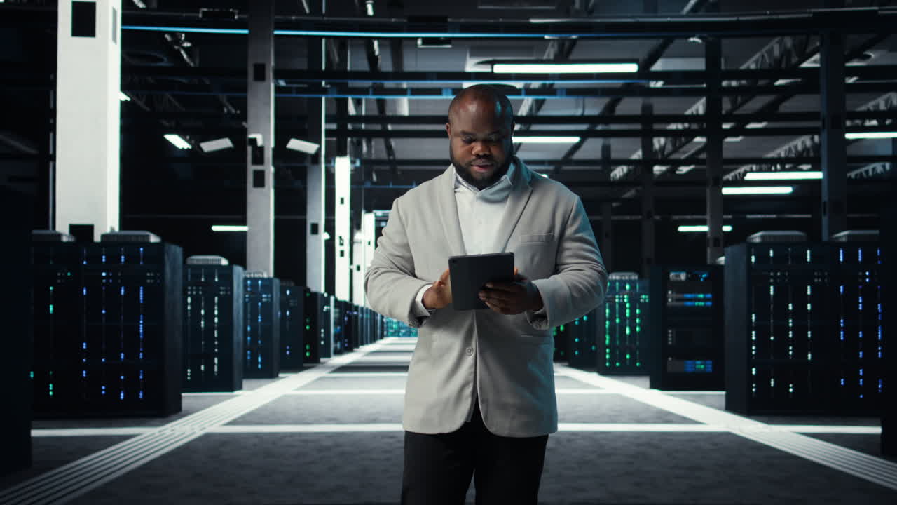 Vertical video IT professional looking over data center checkup checklist paperwork on tablet