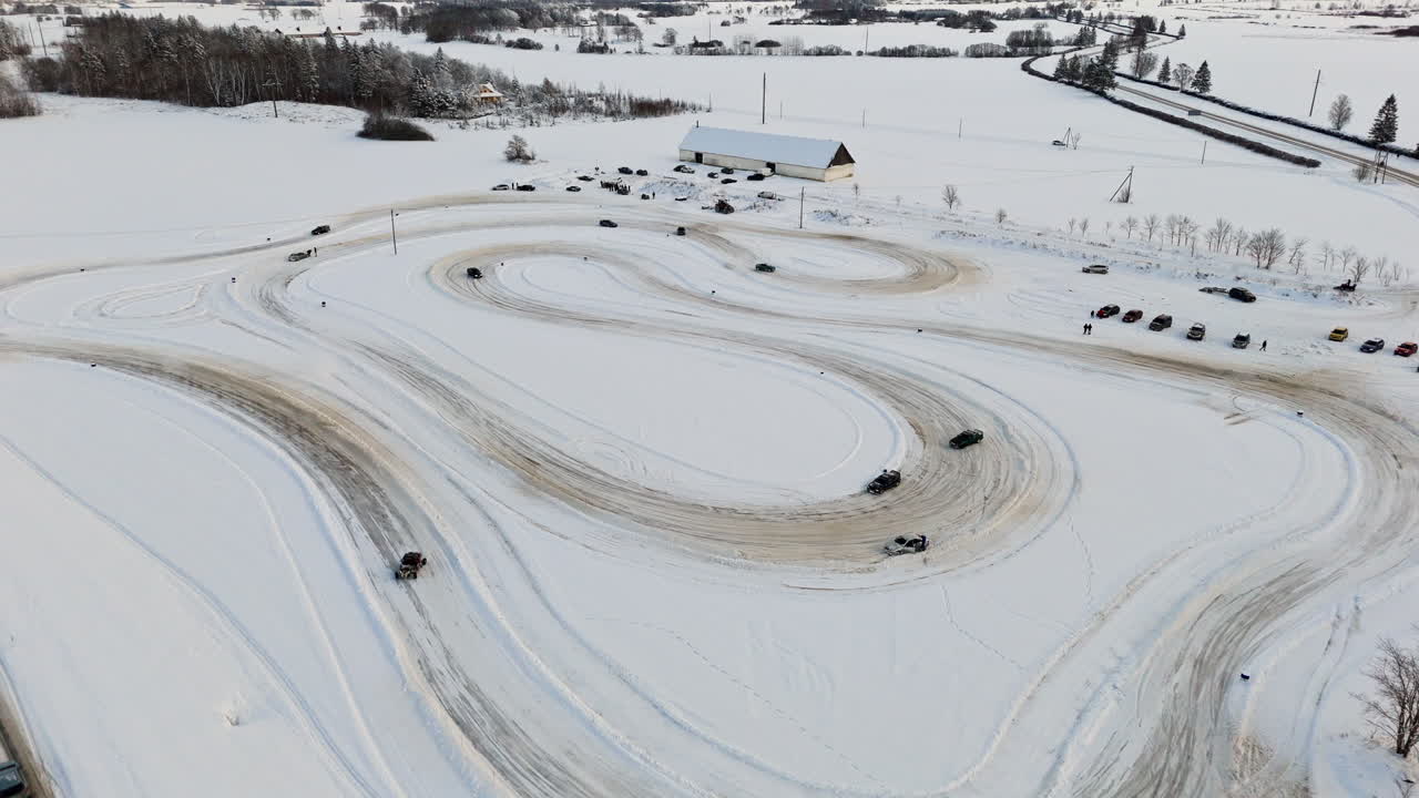 Aerial view around cars racing on a ice track, sunny, winter day in Estonia