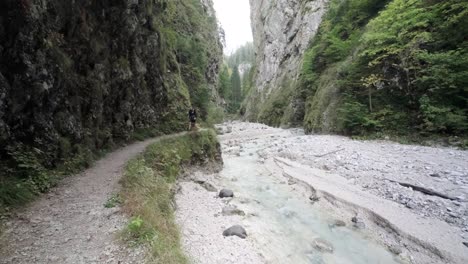 A-man-exploring-Martuljek-Waterfall-during-the-day-in-Gozd-Martljek-in-Slovenia-and-the-Triglav-National-Park