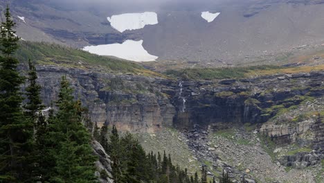 strong winds blowing the waterfall upward, waterfall forming from the melting glacier just above it