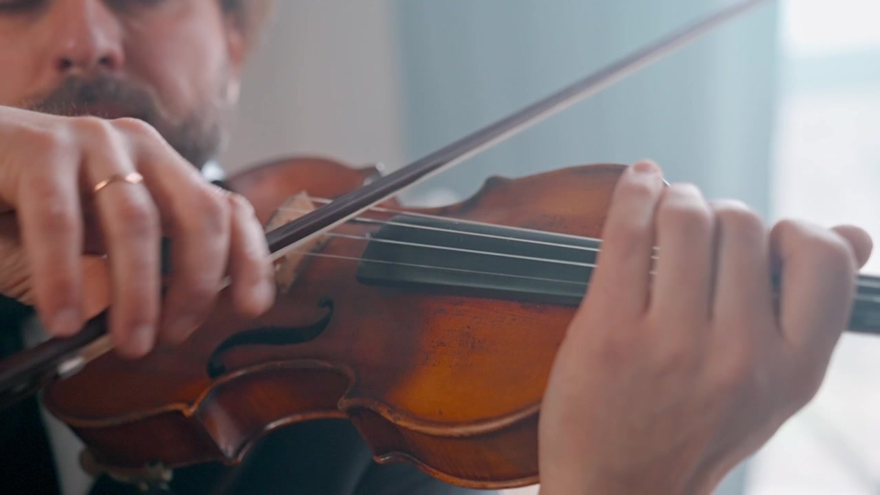 Close-up of a Bearded Man Playing a Classical Violin
