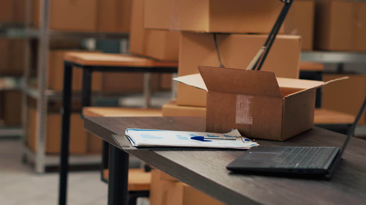 Warehouse Office with Boxes and Laptop