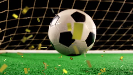 football in front of a goal with confetti falling