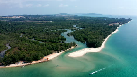aerial drone footage flying over a beach and a mangrove river in cambodia
