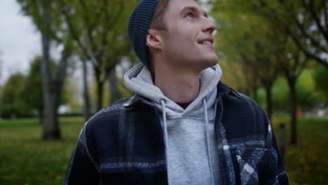 Young-man-looking-around-in-beautiful-autumn-park