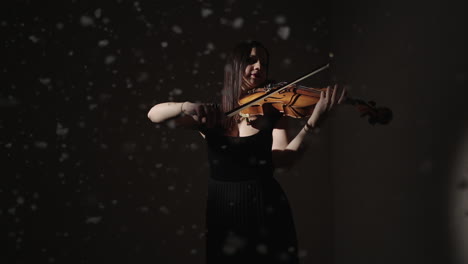 woman playing cello in a dark studio