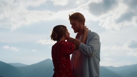 happy family spending honeymoon outdoor. couple admiring each other in mountains