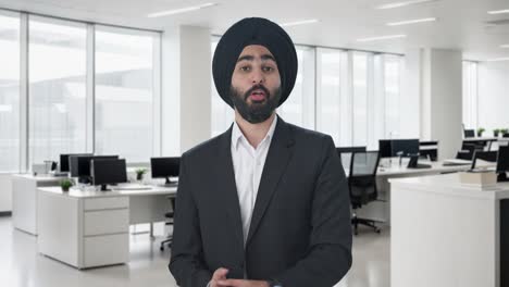 happy sikh indian businessman talking