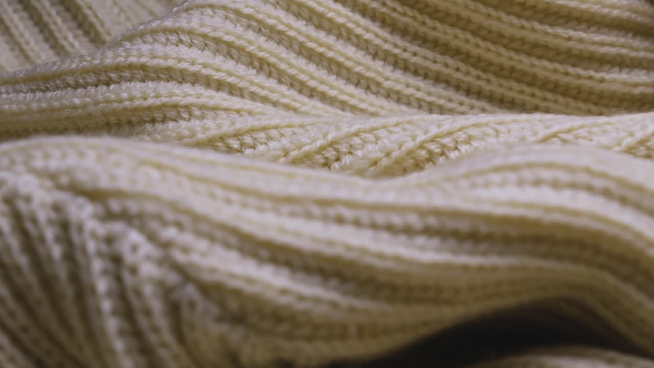 Wool jumper showing ribbed knitting texture pattern design SLIDE SHOT