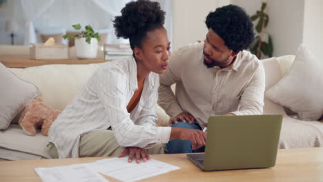couple planning finances at home with laptop