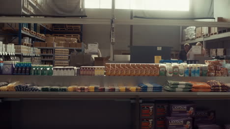 warehouse interior with stocked shelves and workers