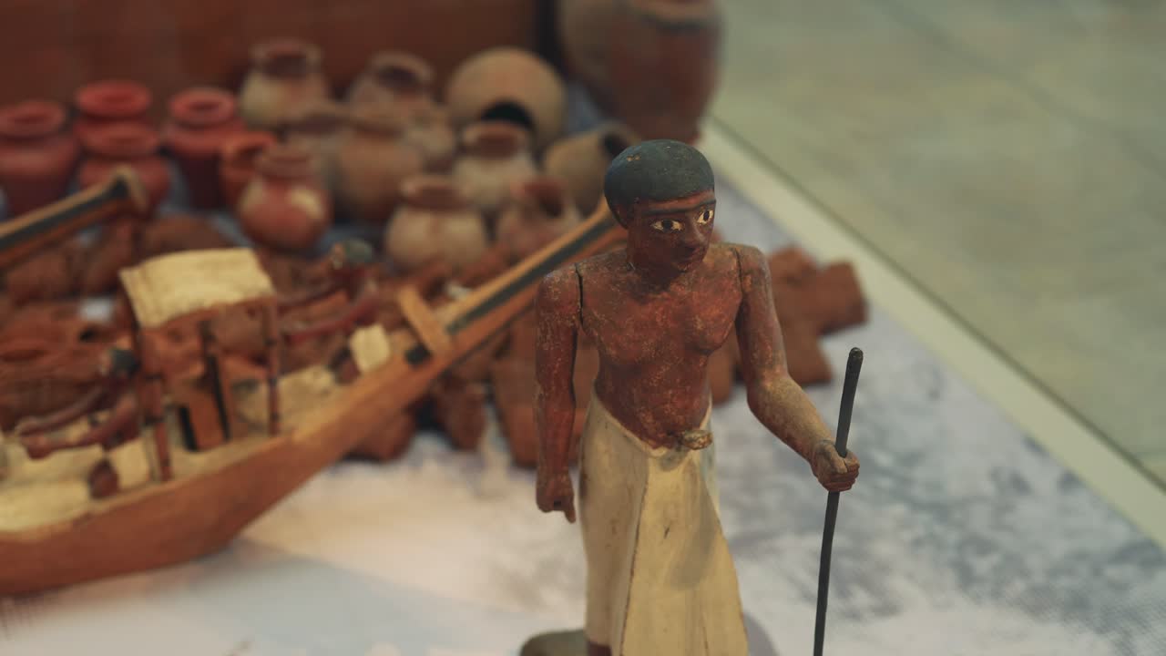 Miniature boat with figures and pottery artifacts