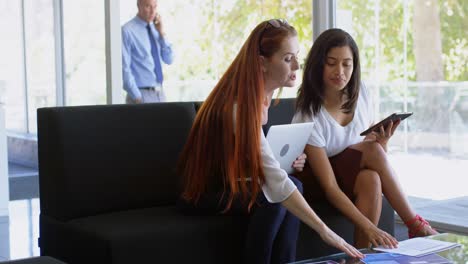 Businesswomen-discussing-over-digital-tablet-4k