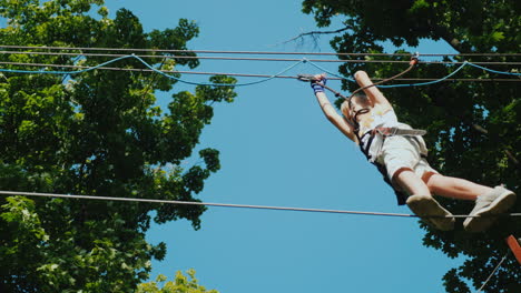 a brave child takes steps on a staggered cable at a height overcome fear concept