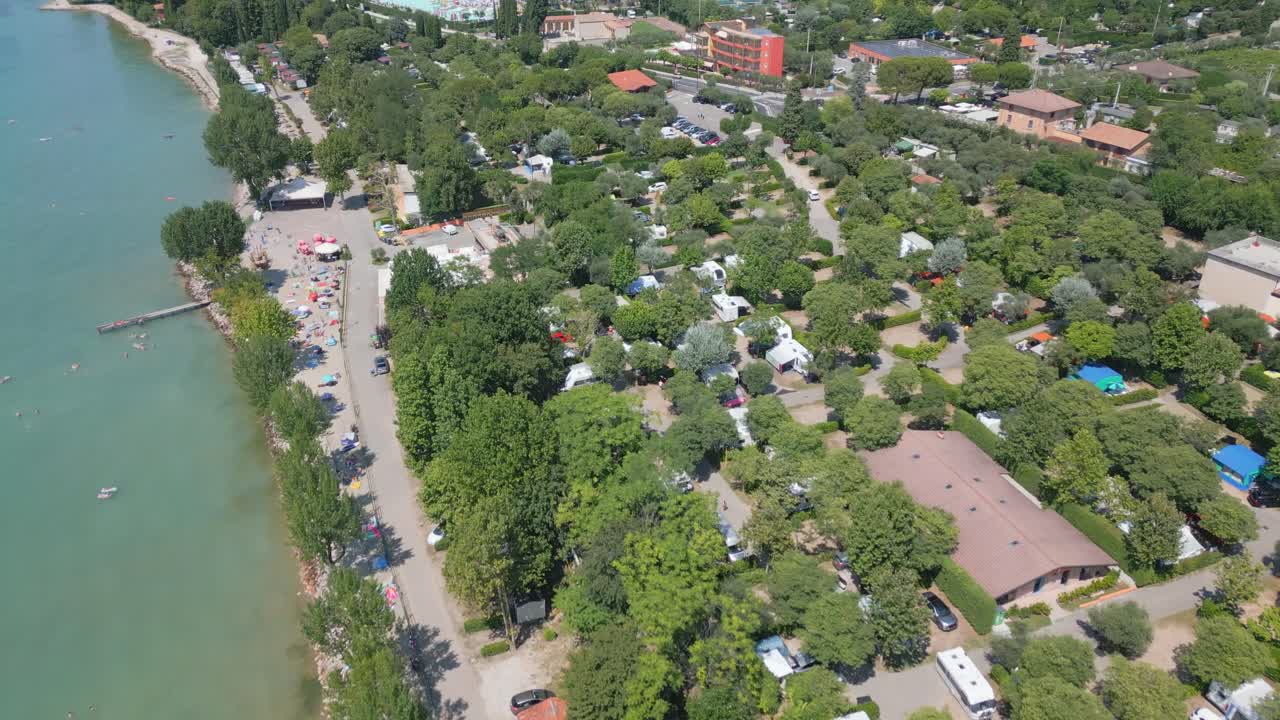 Aerial view trees and woodland around waterfront of Lake Garda in Italy