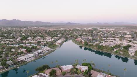 a serene aerial view of scottsdale lake surrounded by residential homes and distant mountain ranges