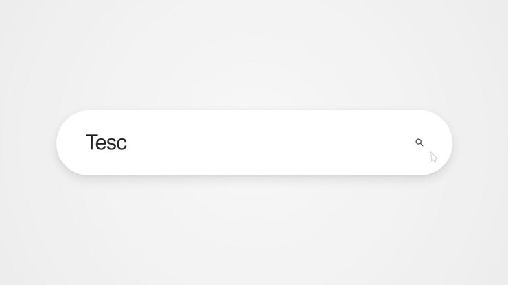 Typing Tesco into a search field, representing online research and web browsing about the British retail company