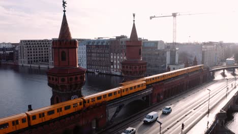 gelbe u-bahnen fahren auf der doppelstöckigen oberbaumbrücke aneinander vorbei