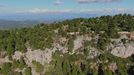 reveal of landscape and sky behind mountain in ippokrateios politeia, greece
