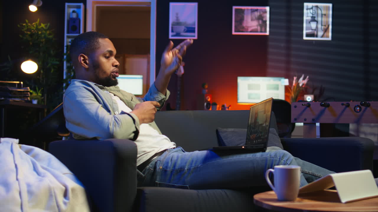 Vertical Video Male remote worker waving at his associates during virtual meeting