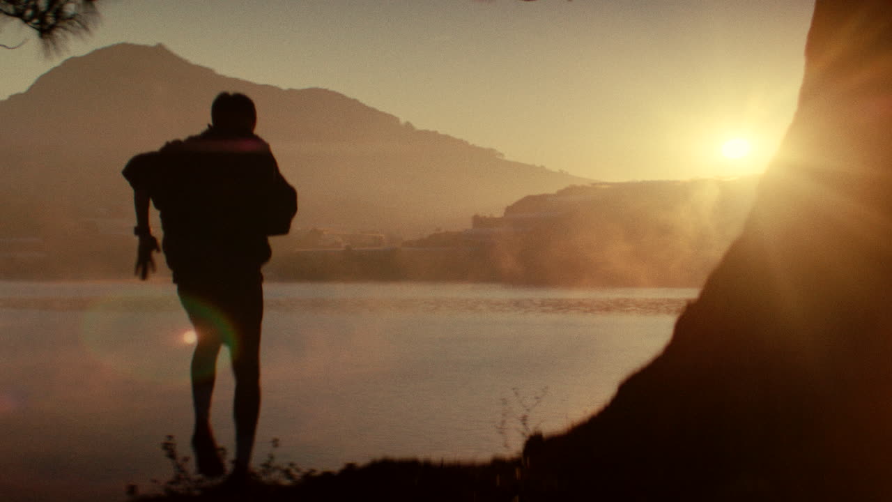 Man Running at Sunrise by the Lake