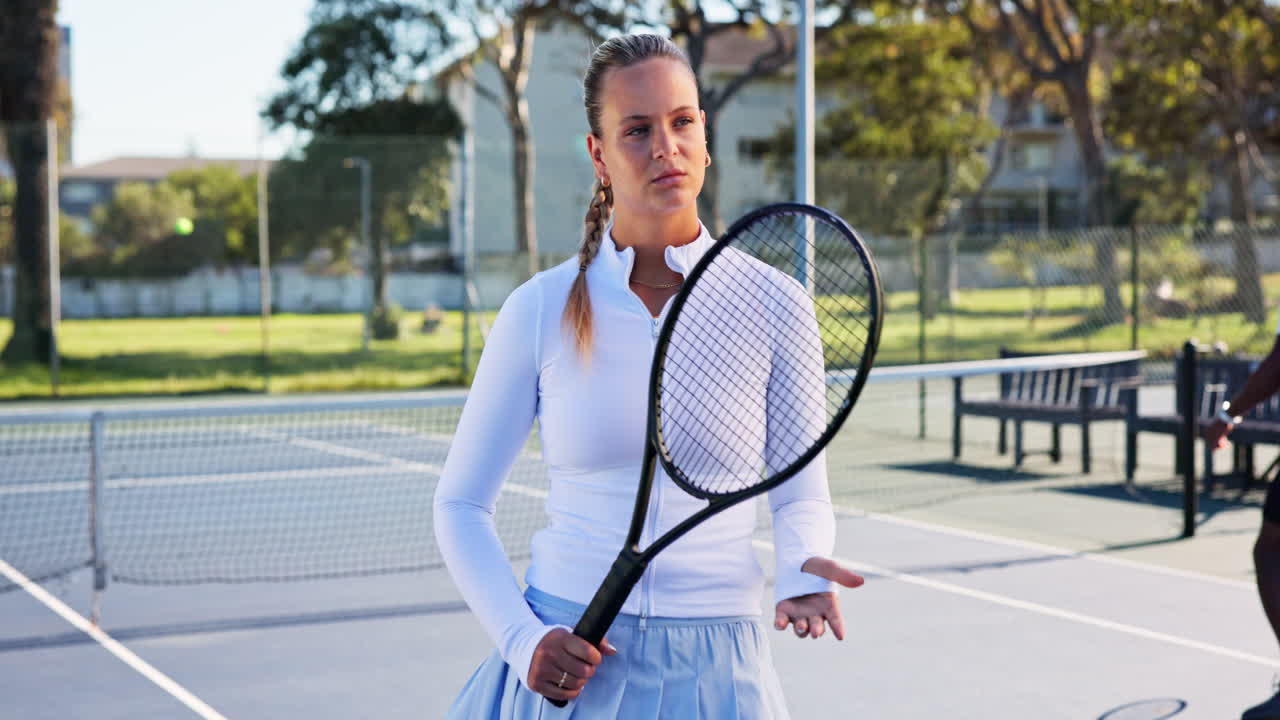 Serious Young Woman Holding Tennis Racket on Outdoor Court
