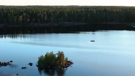 lake, island and boat, forest in background, drone view