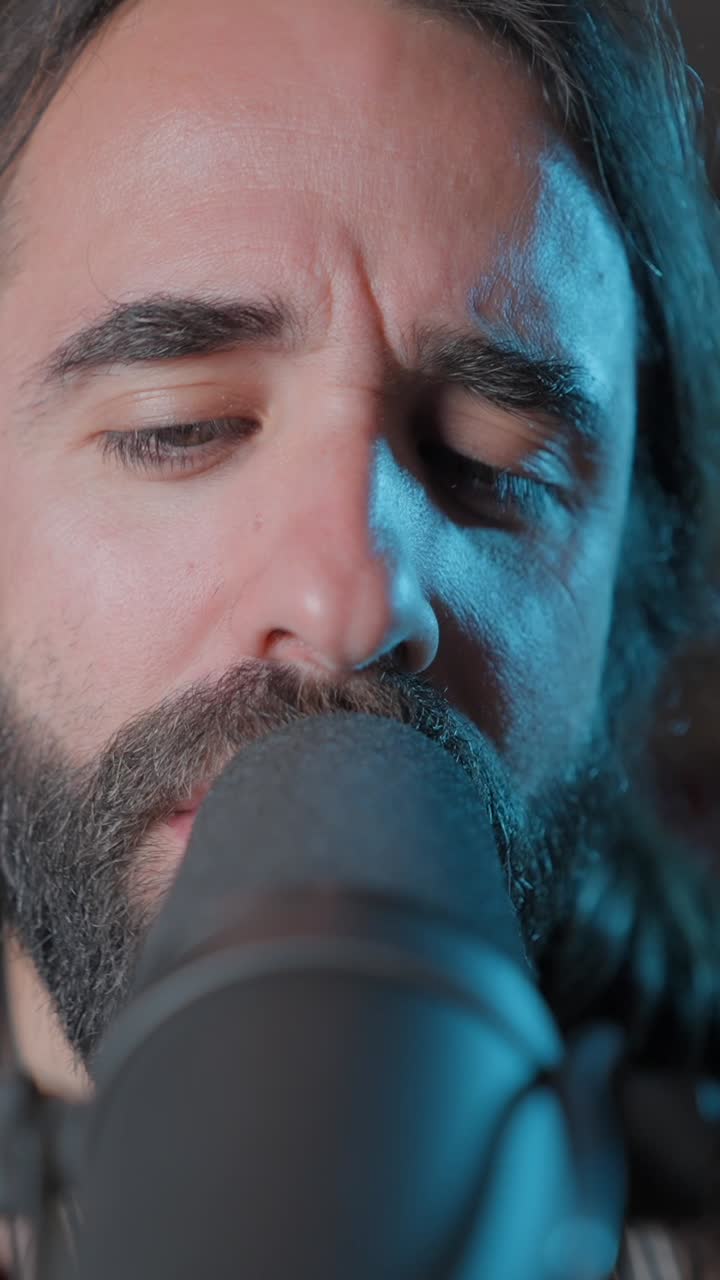 Close-up of a man singing into a microphone