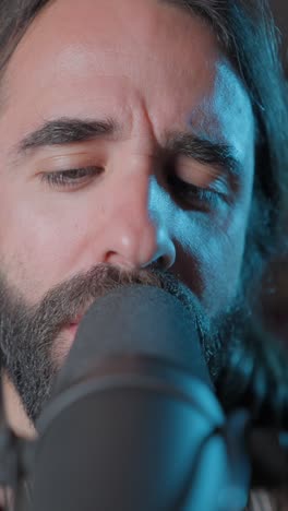 close-up of a man singing into a microphone